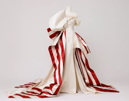 Kate Wasserbach Moore, America 250 Gown, Custom couture gown constructed in 100 percent duchess silk satin , designed and produced in New York City’s Garment District and hand-finished using couture construction techniques, Box for dress: 48 × 48 × 24in. (121.9 × 121.9 × 61cm)
Fiberglass mannequin: 70 × 37 × 37in. (177.8 × 94 × 94cm)
Glossy white round wood pedestal: 12 H × 32 diameter in. (30.5 × 81.3cm), Courtesy of the artist, New York, New York
